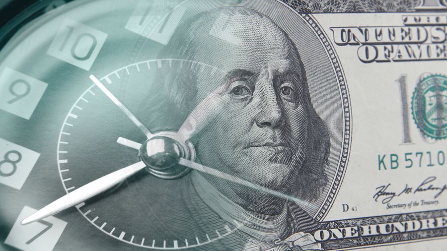 transparent clock over a 100 dollar bill
